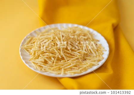 potato straw on yellow background potato straw on yellow background 101413392
