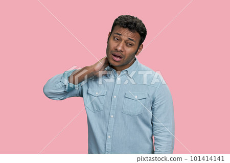 Portrait of indian man suffering from neckache. Isolated on pink background. Portrait of indian man suffering from neckache. Isolated on pink background. 101414141