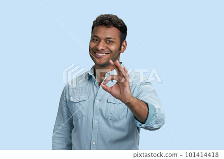 Portrait of indian businessman showing okay gesture. Isolated on pastel blue background. Portrait of indian businessman showing okay gesture. Isolated on pastel blue background. 101414418