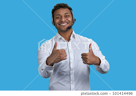 Portrait of indian businessman wearing headset showing two thumbs up. Isolated on blue. Portrait of indian businessman wearing headset showing two thumbs up. Isolated on blue. 101414496