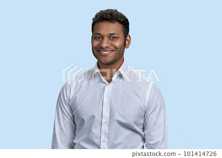 Portrait of a young cheerful indian man smiling with teeth. Isolated on blue background. 101414726
