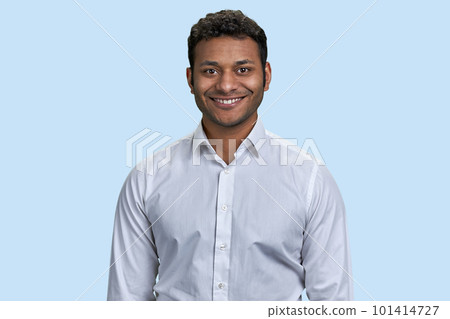 Portrait of a young indian man smiling with teeth. Isolated on blue background. 101414727