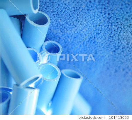 Blue pipe and plastic polymer pellets raw material for blue pvc pipe production. Industrial plastic resin. Chemical polymer granules. Thermoplastic. Plastic from petrochemical and compound extrusion. 101415063