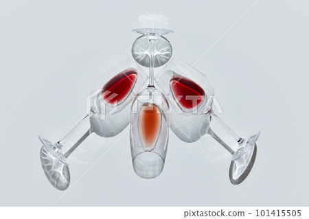 Art of liquid. Three glasses filled with delicious wine, lying against white background. Traditional taste Art of liquid. Three glasses filled with delicious wine, lying against white background. Traditional taste 101415505