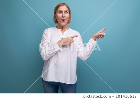 surprised shocked middle aged blonde bob woman in white blouse on studio background 101416612