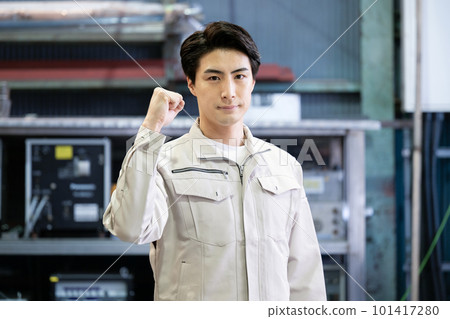 An image of a man doing a fist pump in his work clothes 101417280