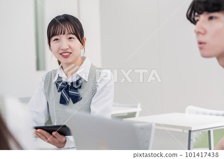 High school students discussing while using a tablet High school students discussing while using a tablet 101417438