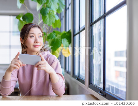 A woman operating a smartphone 101420106
