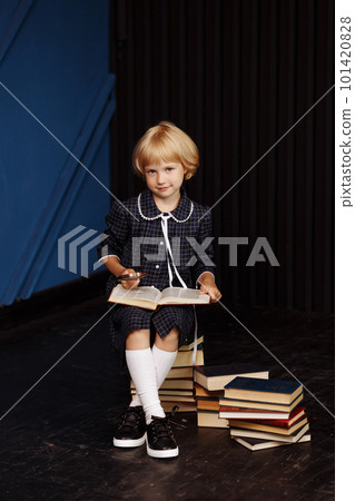 Little schoolgirl in a plaid school uniform 101420828