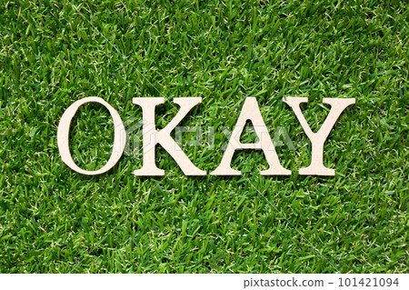 Wood alphabet letter in word okay on artificial green grass background 101421094