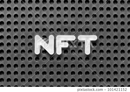 White alphabet letter in word NFT (Abbreviation of Non-fungible token) on black pegboard background 101421152