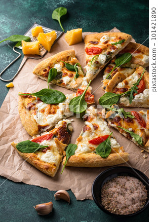 Italian pizza with feta cheese, tomato and basil 101421890