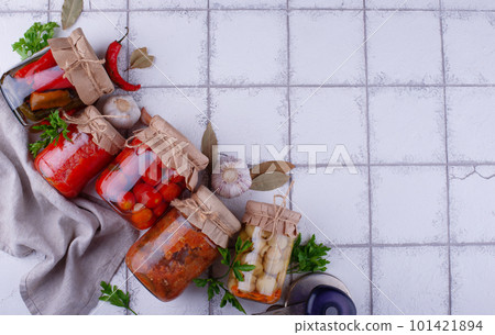 Pickled vegetables in glass jars. 101421894