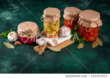 Pickled vegetables in glass jars. 101421913