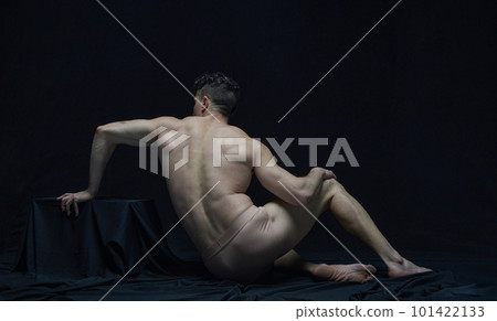 Statue. Back view portrait of muscular shirtless man posing in underwear against black studio background. Like antique sculpture. Statue. Back view portrait of muscular shirtless man posing in underwear against black studio background. Like antique sculpture. 101422133
