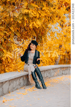 A woman walks outdoors in autumn, enjoys the autumn weather. 101422348