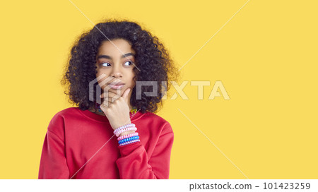 Curious child isolated on yellow background looking aside at copy space and thinking Curious child isolated on yellow background looking aside at copy space and thinking 101423259