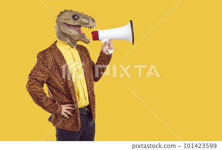 Creative man with dinosaur head makes loud advertisement with help of loudspeaker. 101423599