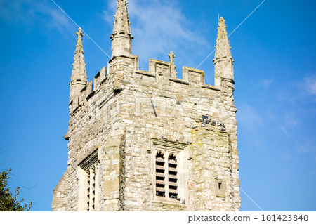 A historic stone block church with a clock tower under the blue sky in the suburbs of London A historic stone block church with a clock tower under the blue sky in the suburbs of London 101423840