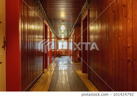 Corridor with wooden paneling inside a mountain cottage. 101424792