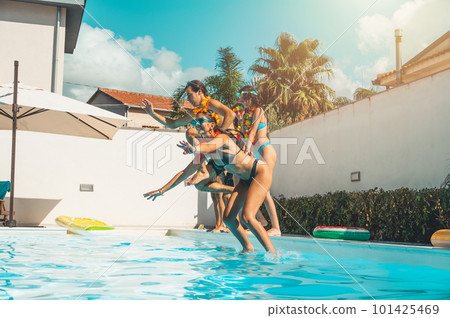 Group of friends in swimsuit enjoy in a swimming pool 101425469