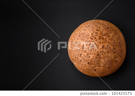 Fresh crispy brown bread with sesame seeds and spices 101425573