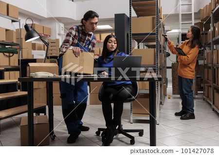 Sotrehouse employees doing delivery route optimization on laptop. Warehouse asian man and woman coworkers preparing parcel for shipment and checking orders checklist on computer Sotrehouse employees doing delivery route optimization on laptop. Warehouse asian man and woman coworkers preparing parcel for shipment and checking orders checklist on computer 101427078