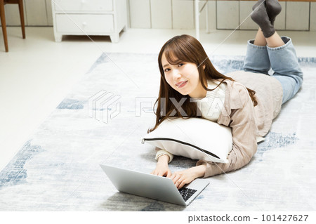 A young woman operating a laptop A young woman operating a laptop 101427627