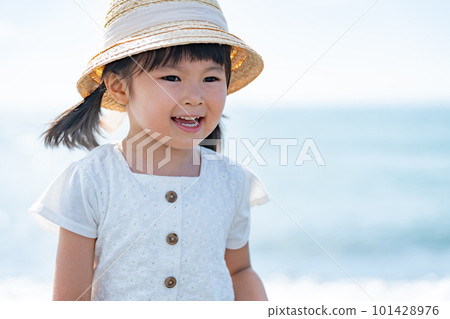 A child walking along the beach A child walking along the beach 101428976