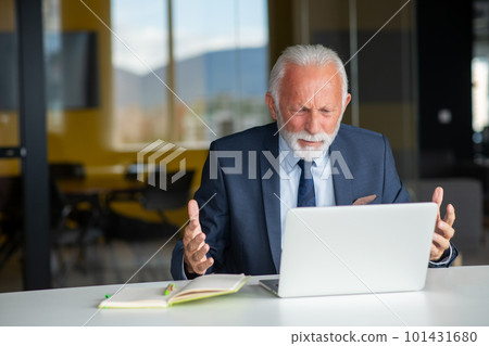 Handsome smiling senior man while sitting at his cozy workplace with laptop at home, retired male chatting with friends in social media, Handsome smiling senior man while sitting at his cozy workplace with laptop at home, retired male chatting with friends in social media, 101431680