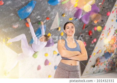Young woman posing on climbing wall 101432331