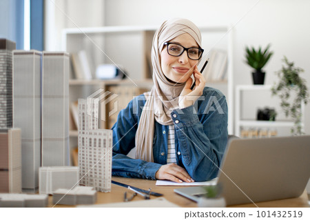 Female working on laptop in real estate office 101432519