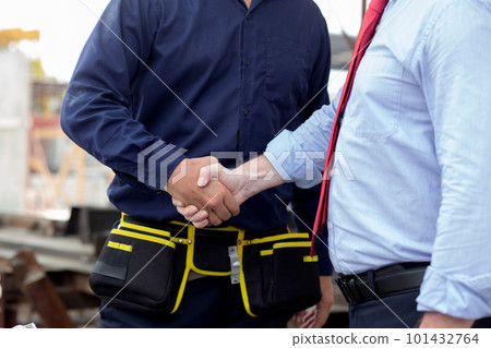 Young engineer caucasian man handshake with partner while negotiation about agreement. Young engineer caucasian man handshake with partner while negotiation about agreement. 101432764