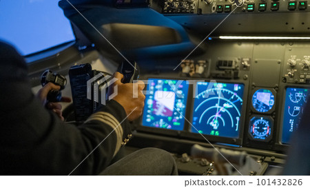 A man is studying to be a pilot in a flight simulator. Close-up of male hands navigating an aircraft. 101432826