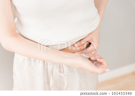 A woman who pinches her stomach and injects insulin injection, diet injection, fertility drug A woman who pinches her stomach and injects insulin injection, diet injection, fertility drug 101433340