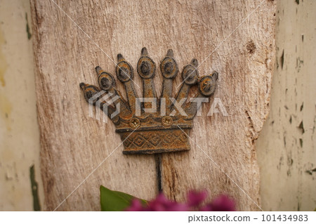 Vintage ornament element of crown, antique gold floral designs. isolared on wood. Selective focus Vintage ornament element of crown, antique gold floral designs. isolared on wood. Selective focus 101434983