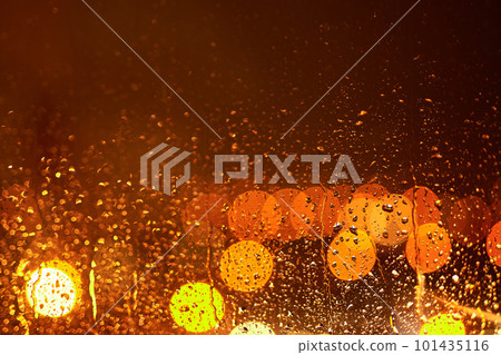 Raindrops on the glass against the backdrop of the night city. Beautiful bokeh on the background of glass. 101435116