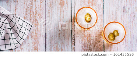 Alcoholic cocktail orange margarita with egg foam, jalapeno pepper and tajine top view web banner Alcoholic cocktail orange margarita with egg foam, jalapeno pepper and tajine top view web banner 101435556