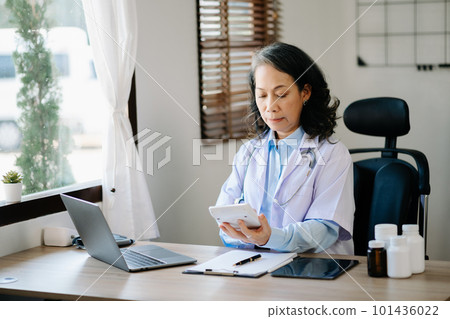 Medical technology concept. Doctor working with mobile phone and stethoscope in modern office Medical technology concept. Doctor working with mobile phone and stethoscope in modern office 101436022