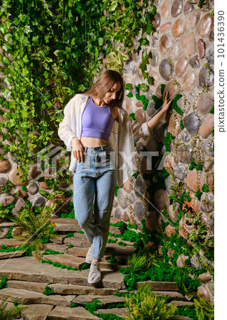 Young woman descending the stone path 101436390