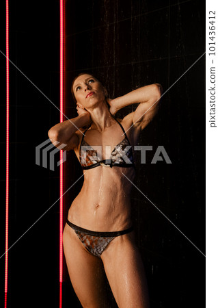 Portrait of athletic adult woman in pool shower 101436412