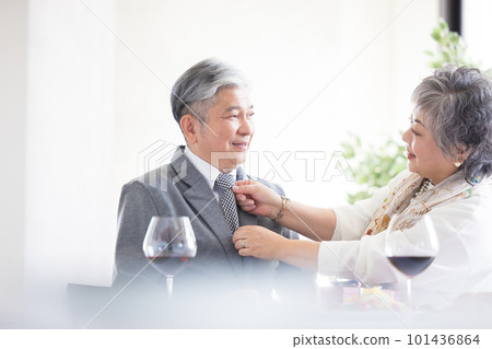 Senior couple A man having his tie fixed 101436864