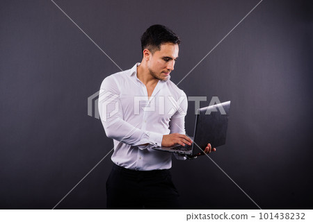 Cheerful young guy 20s in classic shirt isolated on dark wall background studio portrait. 101438232