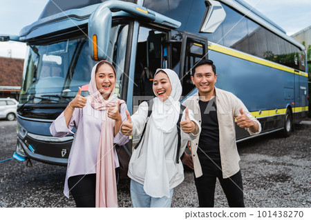 three young traveler smile showing thumb in front of the bus three young traveler smile showing thumb in front of the bus 101438270