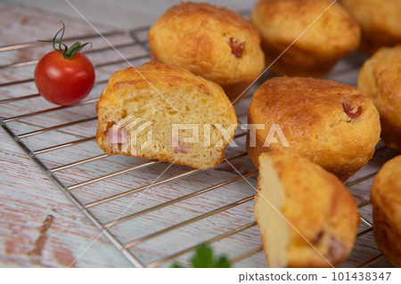 Savory muffin with ham and cheese on blue background Savory muffin with ham and cheese on blue background 101438347