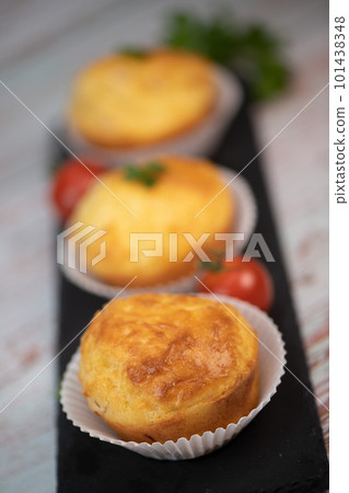 Savory muffin with ham and cheese on blue background Savory muffin with ham and cheese on blue background 101438348