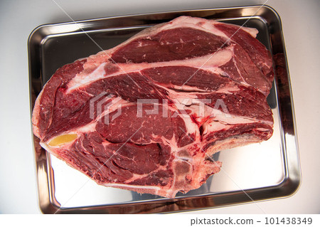 Raw cowboy steak with seasonings on white background, prime rib eye on bone 101438349