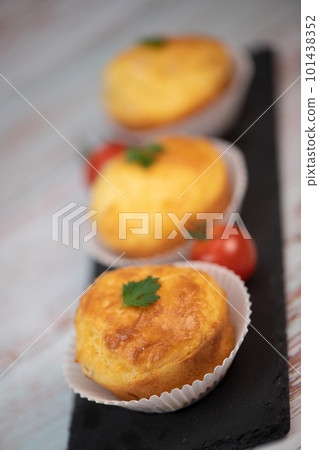 Savory muffin with ham and cheese on blue background Savory muffin with ham and cheese on blue background 101438352
