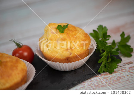 Savory muffin with ham and cheese on blue background 101438362