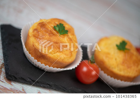 Savory muffin with ham and cheese on blue background 101438365